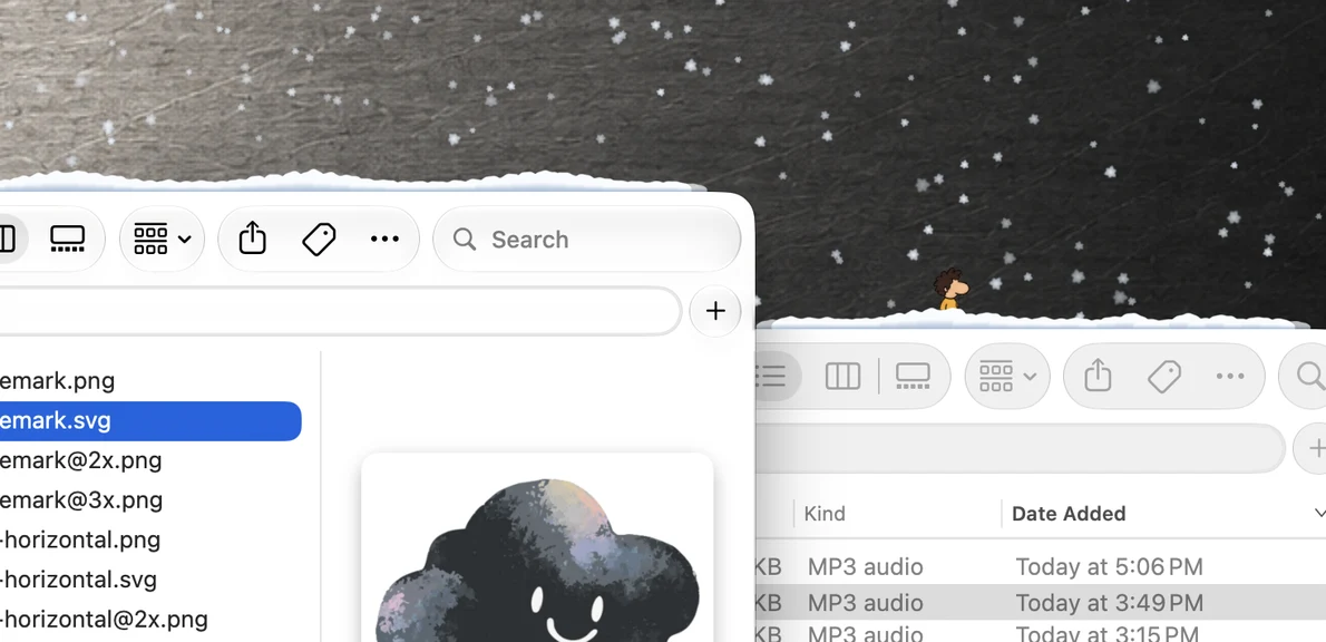 Snow falling among Mac windows, with snow gathered on their top edges and a Ling on a snowy window ledge.